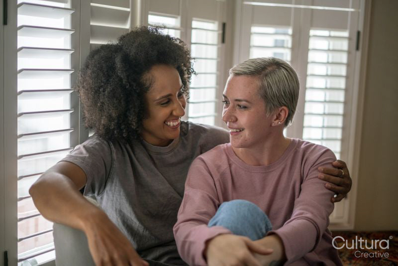 Smiling couple embracing at home