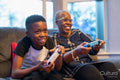 Grandmother and grandson playing video game at home