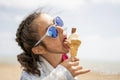 Girl eating ice cream on beach