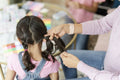 Mother doing daughter braids