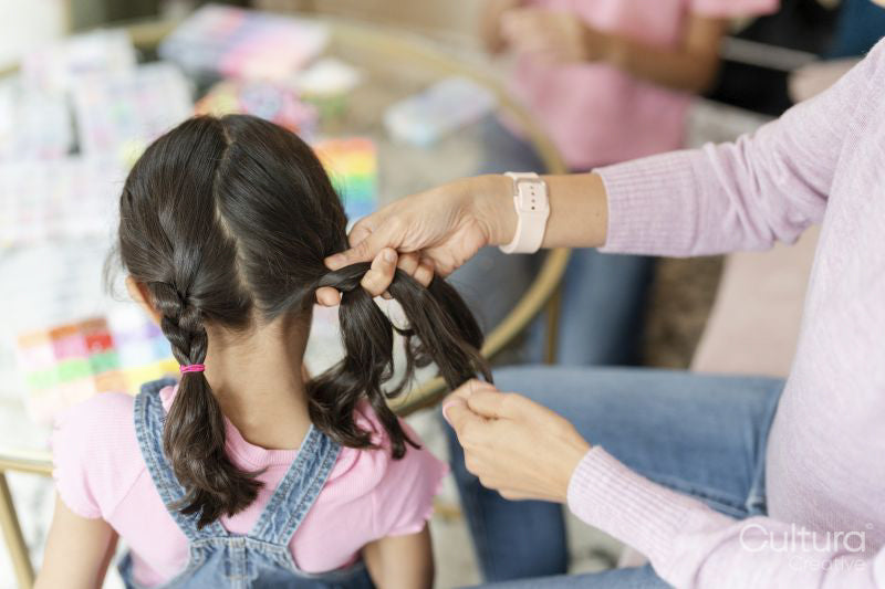 Mother doing daughter braids