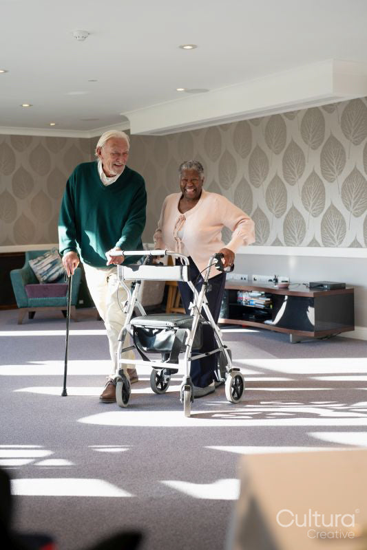 Smiling senior people using mobility walker and cane