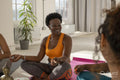 Smiling women sitting in yoga studio