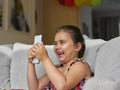 Girl looking at smart phone on sofa