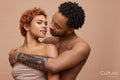 Studio portrait of happy young couple embracing
