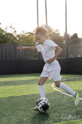 Girl playing soccer on soccer field