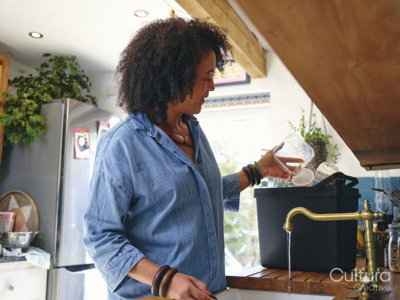 Woman washing dishes at home