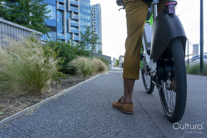 Businessman riding rental bicycle