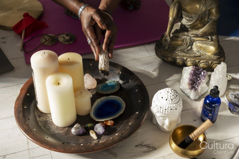 Close-up of woman holding sage incense in yoga studio