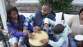 Family with children playing drums on patio