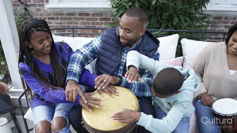 Family with children playing drums on patio