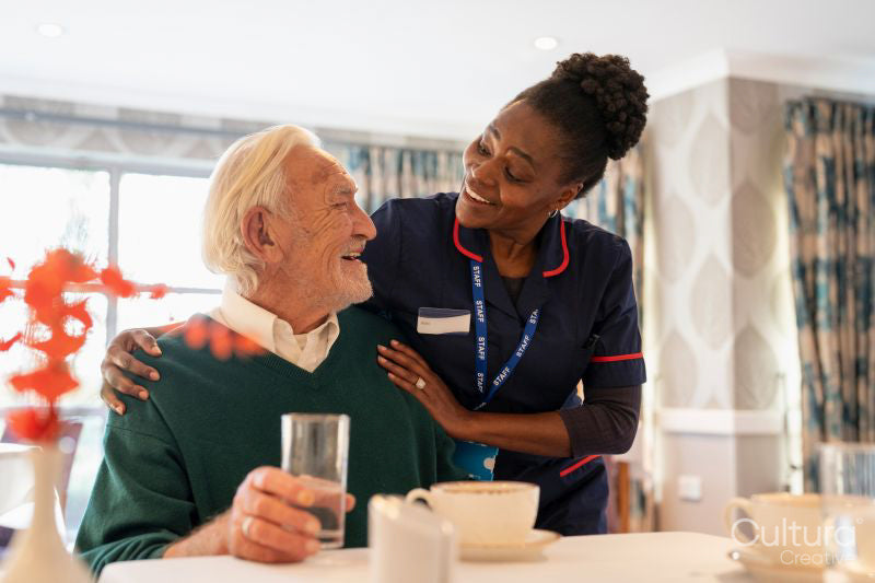 Smiling nurse and senior man in nursing home
