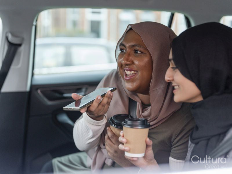 Women sitting in car and talking on phone