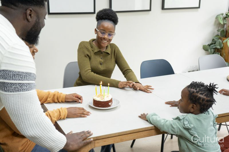 Family with children celebrating birthday at home