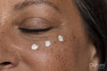 Close-up of woman with dots of eye cream