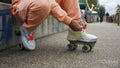 Low section of man tying shoelace on roller skate