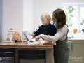 Mother and daughter using digital tablet at home