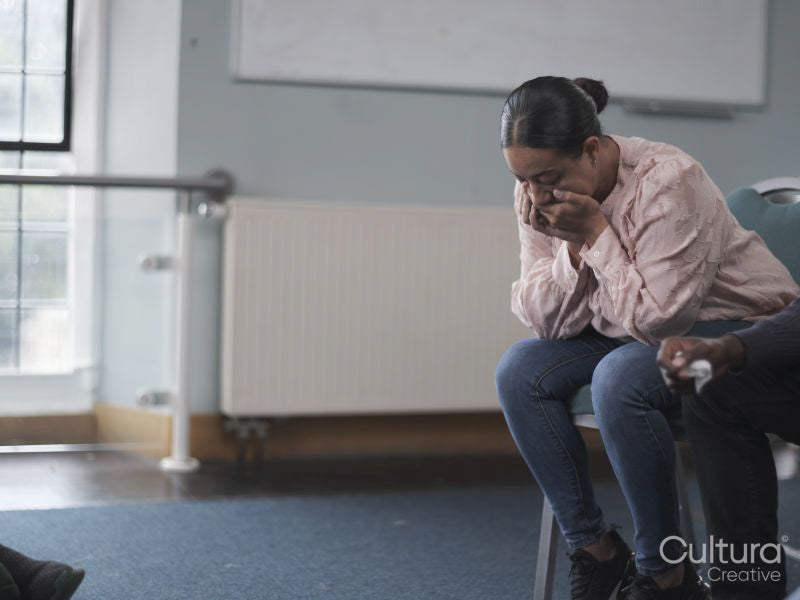 Woman crying in group therapy session