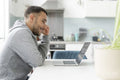 Mature man working on laptop at home