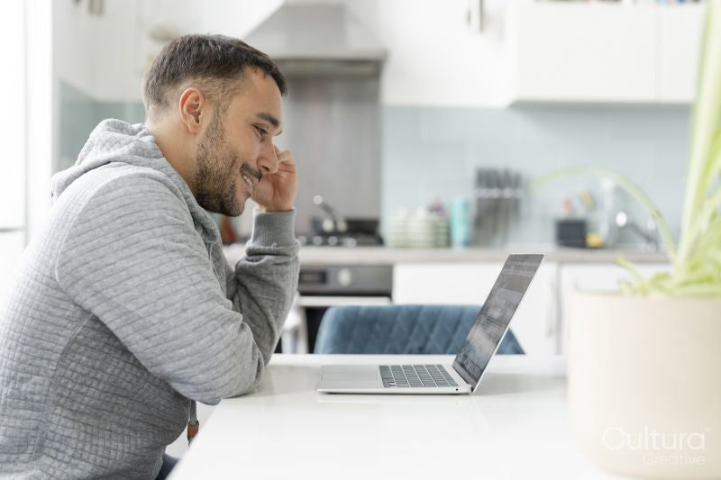 Mature man working on laptop at home