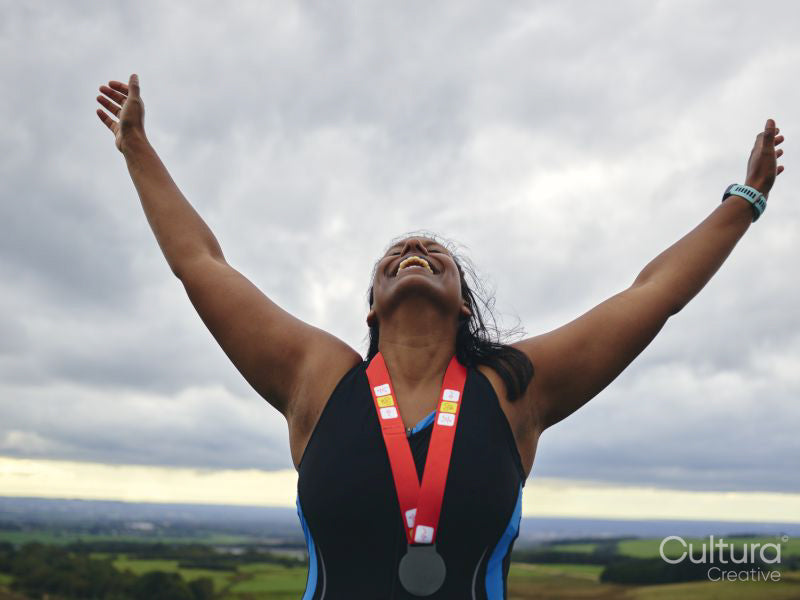 Female athlete celebrating winning medal