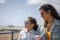 Mother and daughter walking along beach