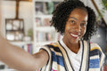 Portrait of smiling woman taking selfie at home