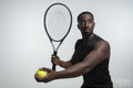 Portrait of man holding tennis ball and racket