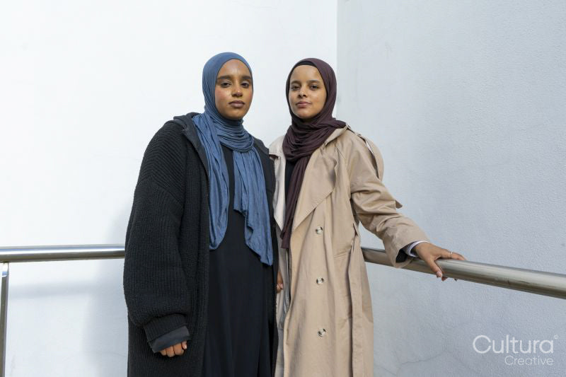 Portrait of two young women wearing hijabs