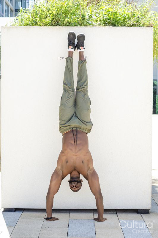 Mid adult man doing handstand