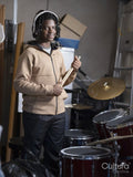 Portrait of teenage boy standing next to drums