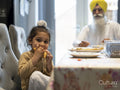 Portrait of boy in traditional clothing eating food