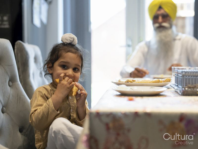 Portrait of boy in traditional clothing eating food