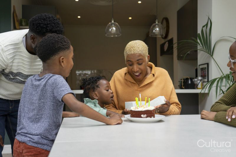 Family with children celebrating birthday at home