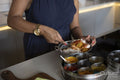 Close-up of woman cooking in kitchen