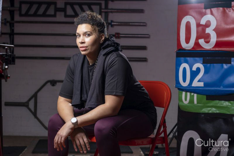 Portrait of woman sitting in gym