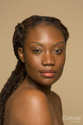 Studio portrait of shirtless woman with braided hair