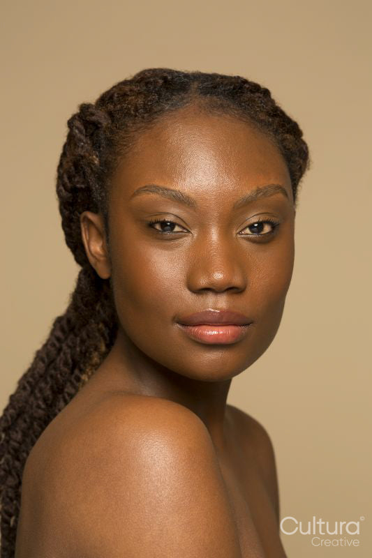 Studio portrait of shirtless woman with braided hair