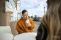 Man and woman sitting at table in sidewalk cafe