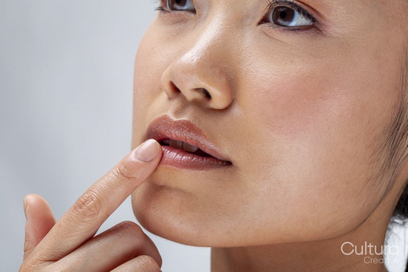 Close-up of woman touching lips