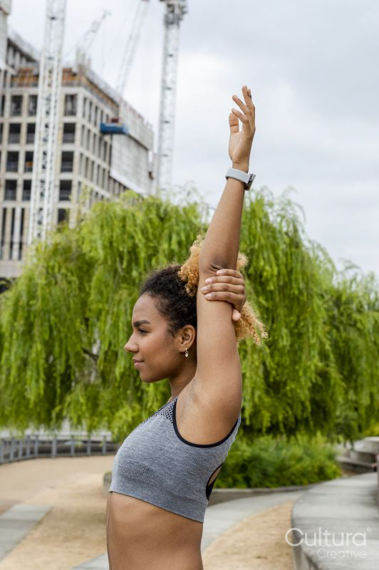 Sporty young woman stretching