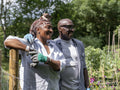Smiling mature couple wearing gardening gloves