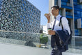Businessman walking in business district and talking on phone