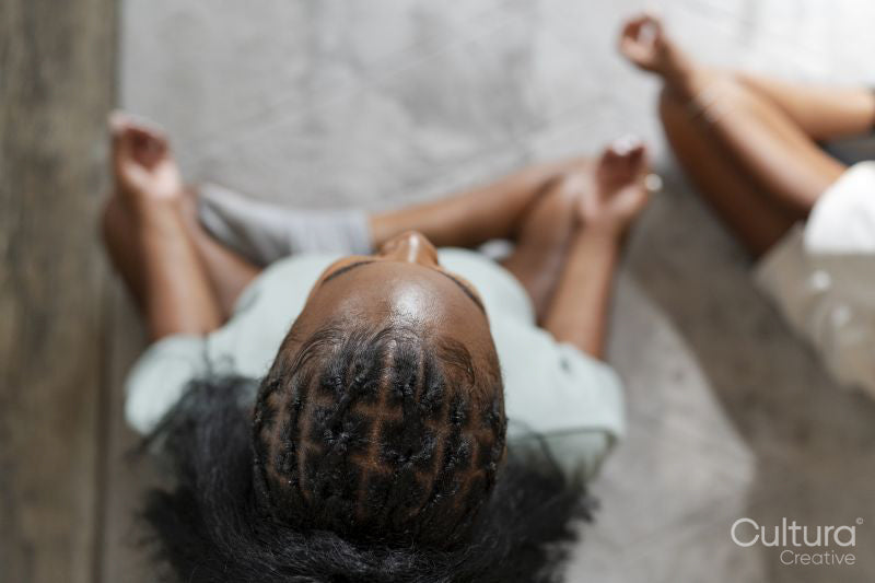 Directly above view of couple practicing yoga at home