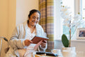 Senior lady sitting with photography at nursing home