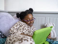 Girl using digital tablet at home