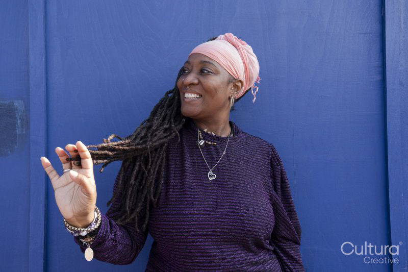 Portrait of beautiful woman with dreadlocks wearing a headscarf