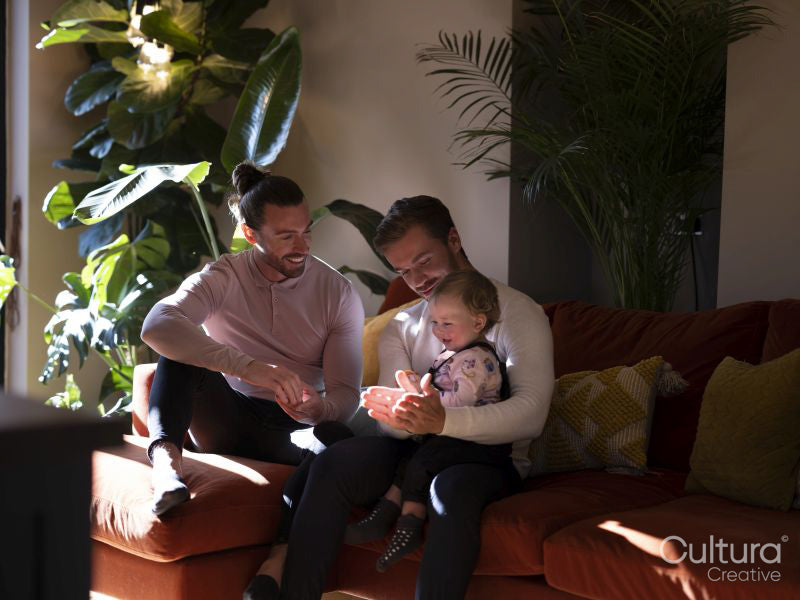 couple playing with baby daughter in living room