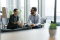 Business people having meeting in office lobby