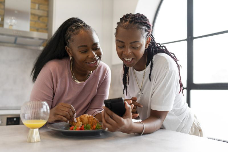 couple using phone during breakfast in kitchen
